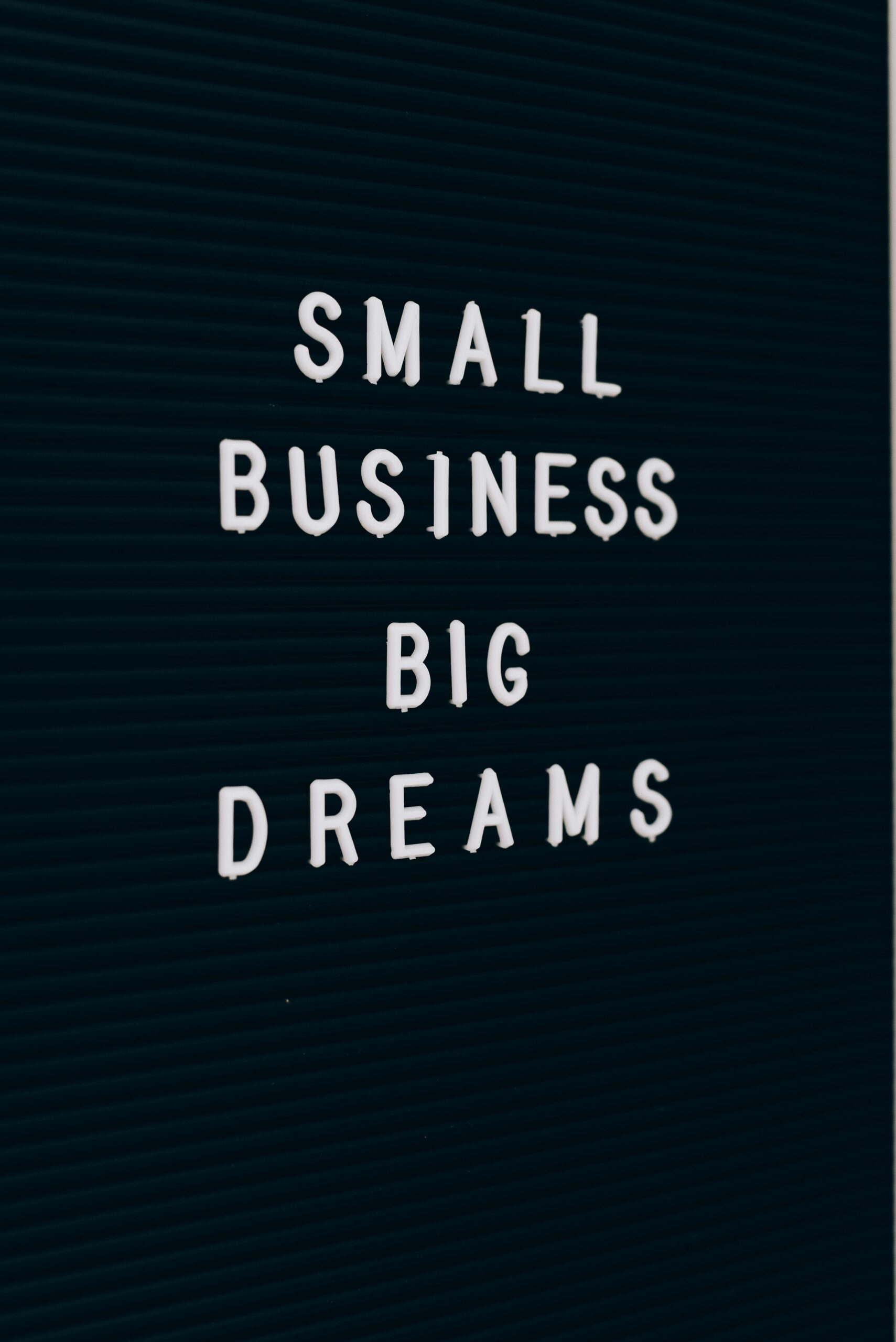 Close-up of a motivational quote about small business dreams on a letter board.