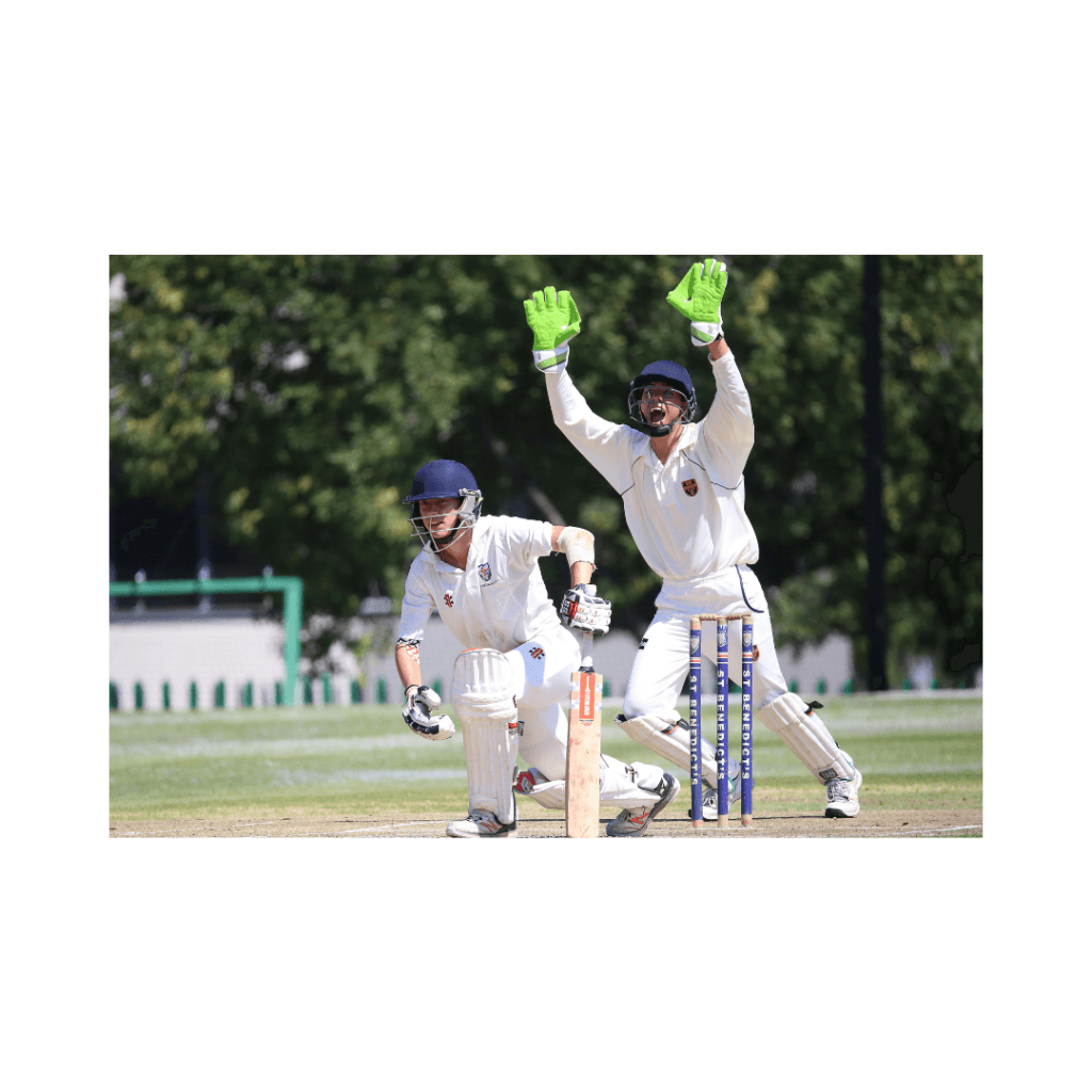 Two children playing cricket outdoors.
